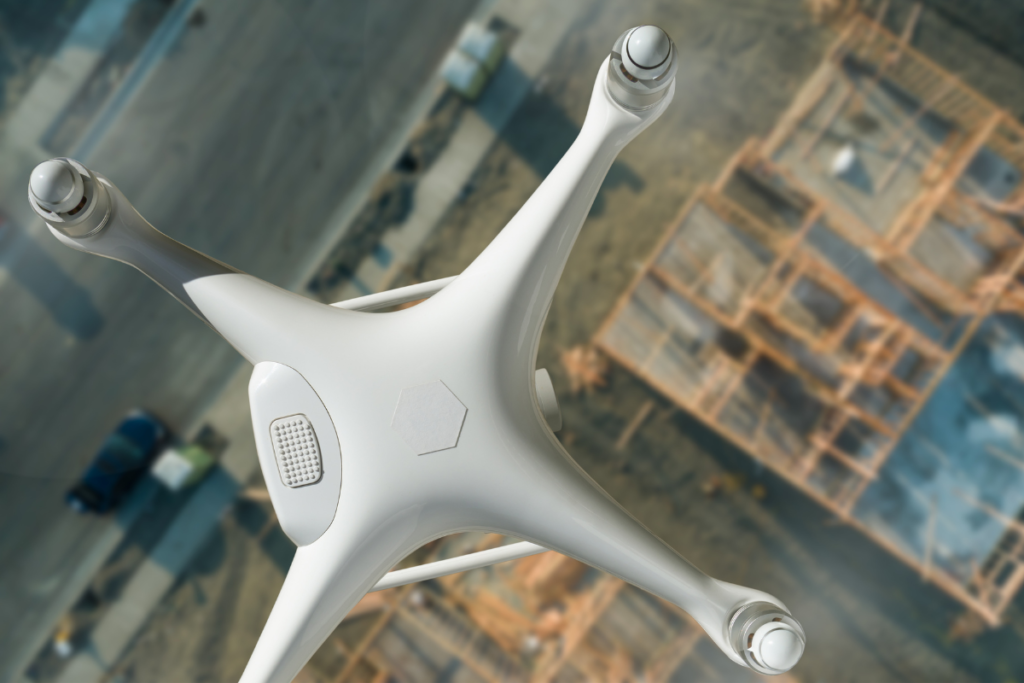 A close-up view of a drone equipped with a gas detection sensor, used for monitoring potential gas leaks in an oil refinery.