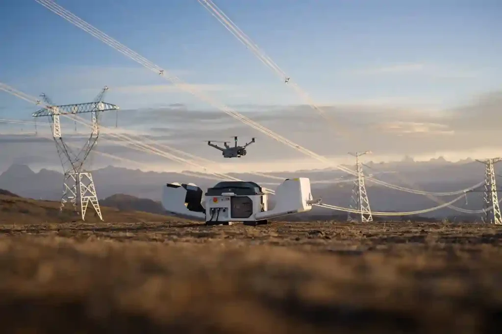 A white DJI Dock 3 station installed on a secure platform overlooking a vast solar farm during the day.
