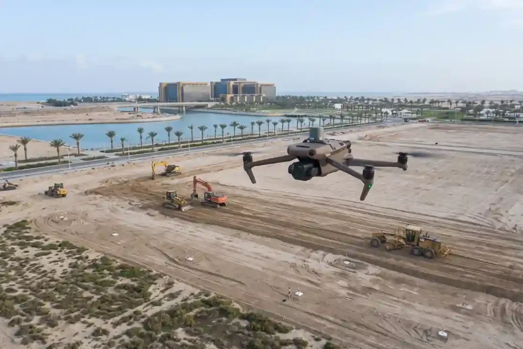 Compact DJI Mavic 3 Enterprise RTK drone flying over a large greenfield industrial SEZ land enablement site.