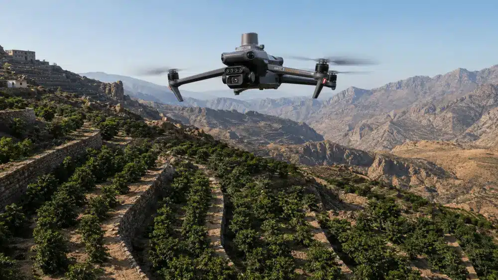 Crop monitoring drone flying over a mountain terrace plantation in Saudi Arabia.