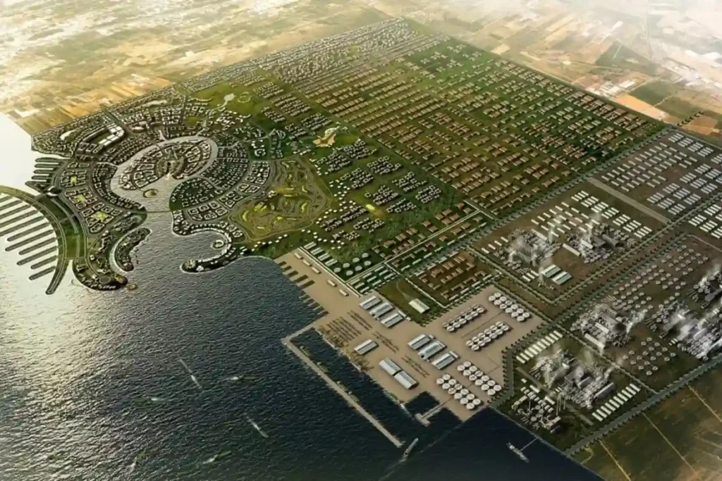 Aerial view of an industrial coastal outfall channel discharging into the clear waters of the Red Sea in Jazan SEZ.