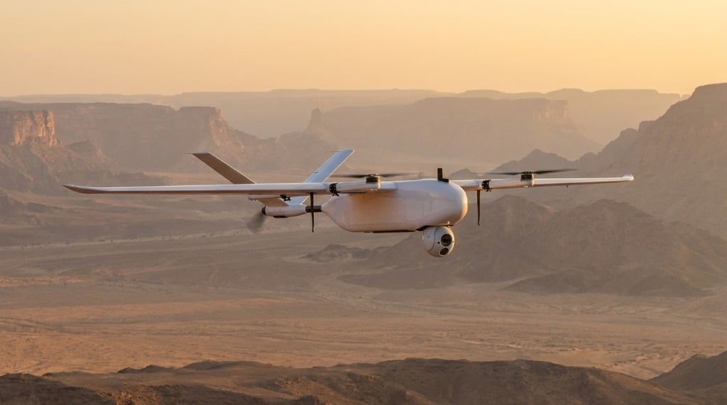 VTOL fixed-wing drone conducting large-area aerial survey and mapping over desert canyon terrain in Saudi Arabia